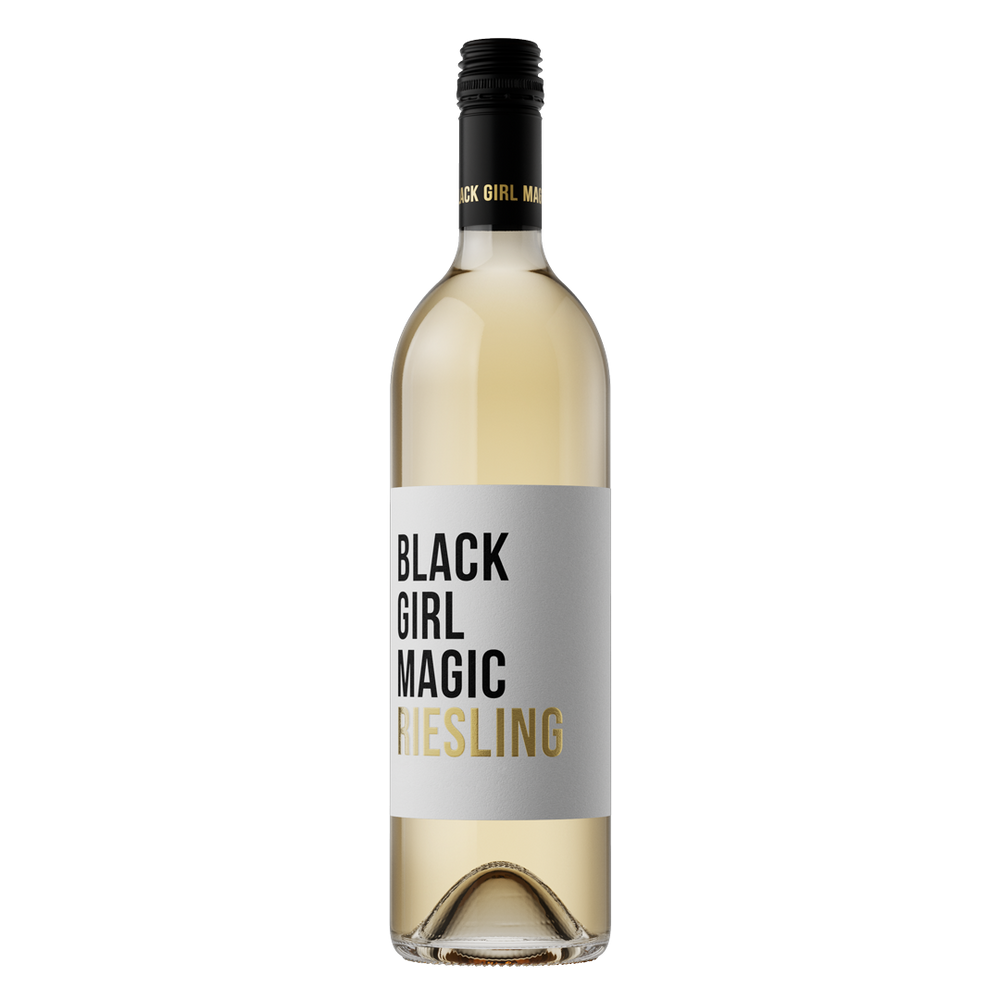 A bottle of white wine with a light gray label featuring the text 'BLACK GIRL MAGIC' in black and gold, with 'RIESLING' written in gold at the bottom. The wine inside is pale yellow.