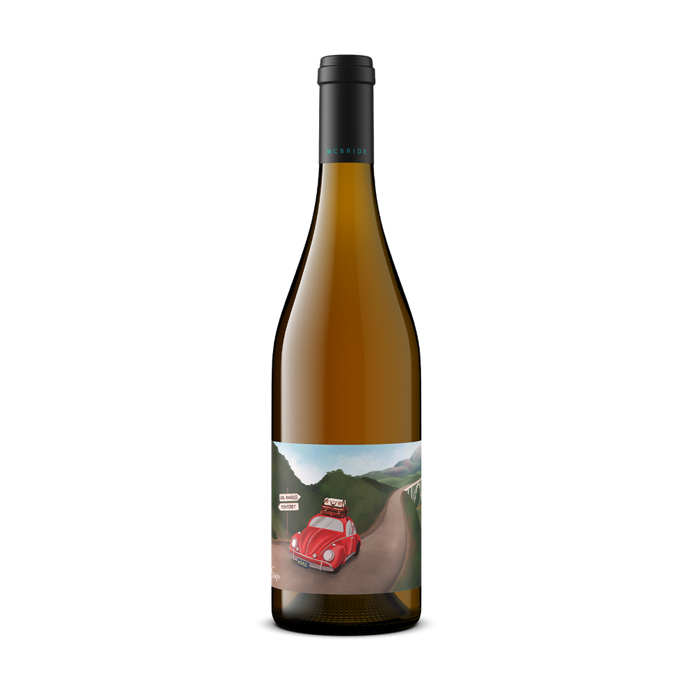 A single bottle of white wine with a black cap and a colorful label showing a red vintage car on a winding road through green hills, photographed on a plain white background.