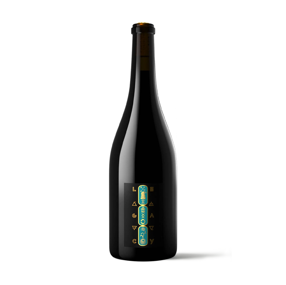 A dark glass bottle with a black label featuring vertical teal and gold lettering, photographed against a solid white background.
