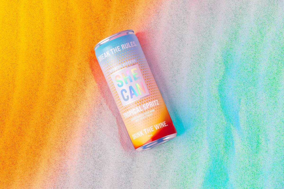 SHE CAN Tropical Spritz canned drink with colorful gradient design